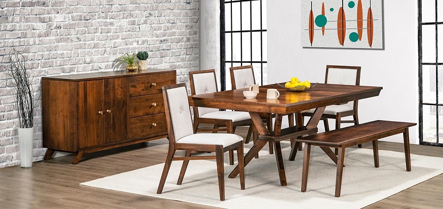 Dark brown wooden dining room table with 6 chairs around it in a corner. A grey brick wall in the background on one side and a painting on the other.