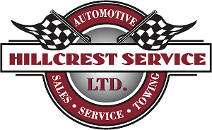 A round logo with two black and white checkered flags. The words Hillcrest Service, automotive, sales, service, towing appear too.